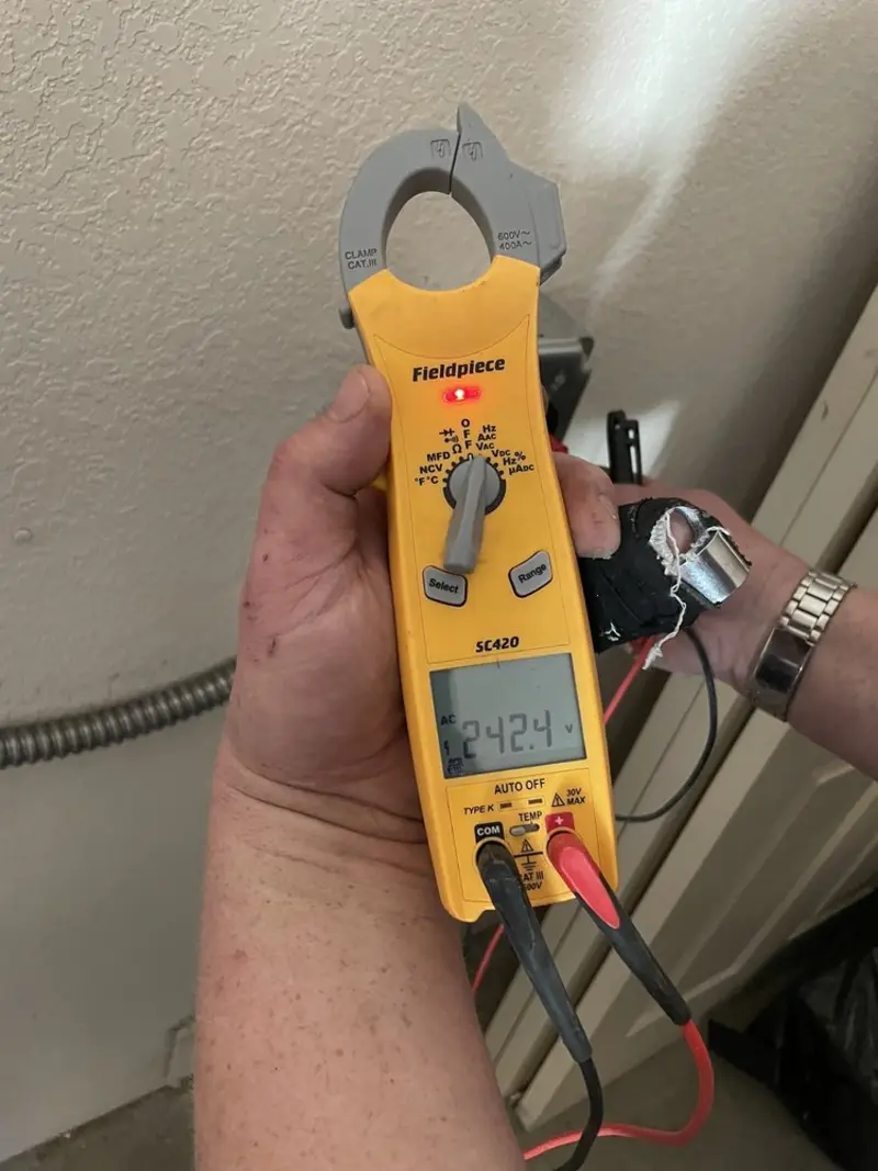 Voltage testing with clamp meter during Recessed Lighting Installation in Kirkwood